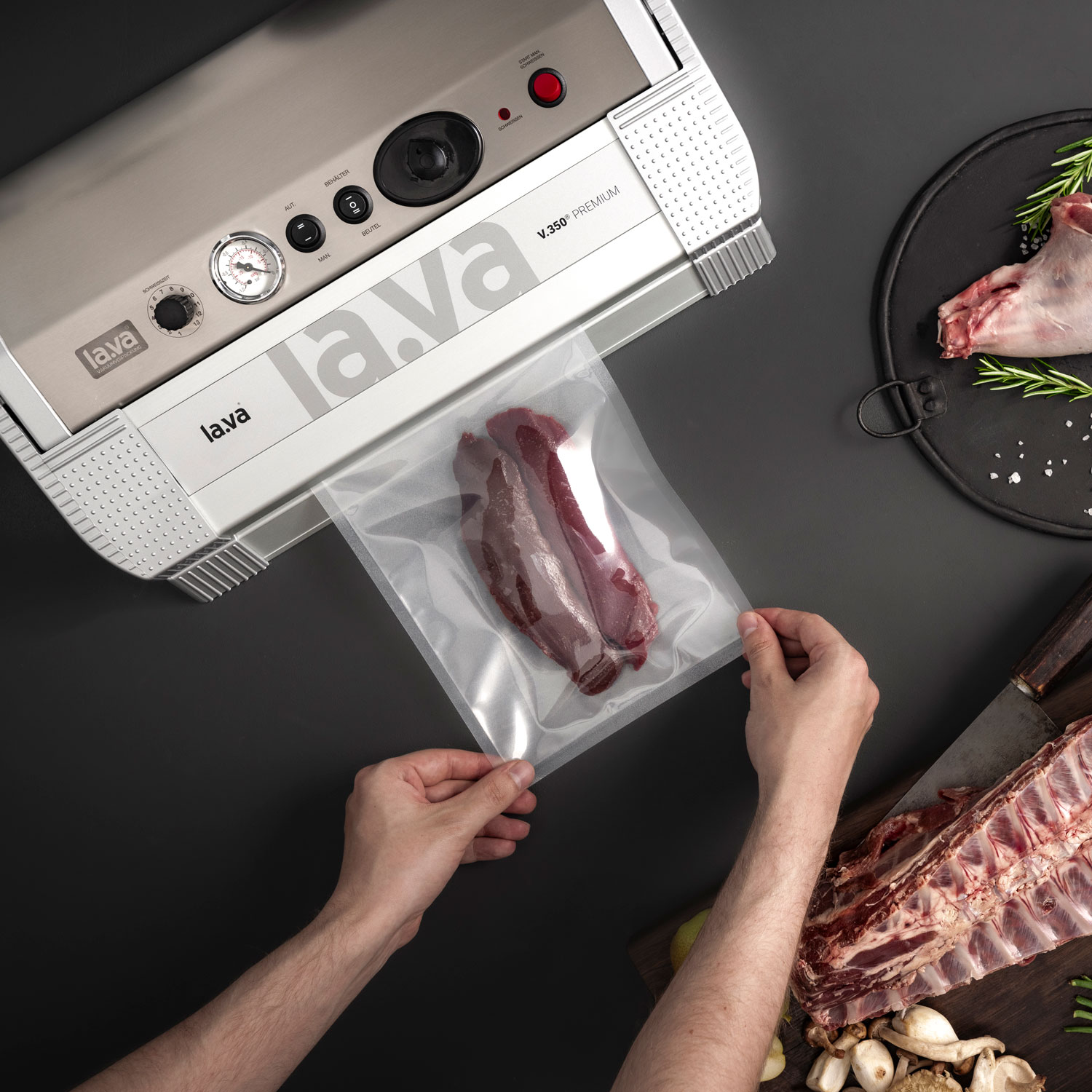 V.350 Premium vacuum sealer during the vacuum process of a piece of game meat, with hands holding the bag