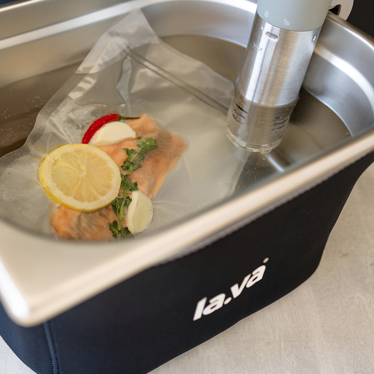 Vacuum bag is cooked in the stainless steel basin with the sous-vide stick