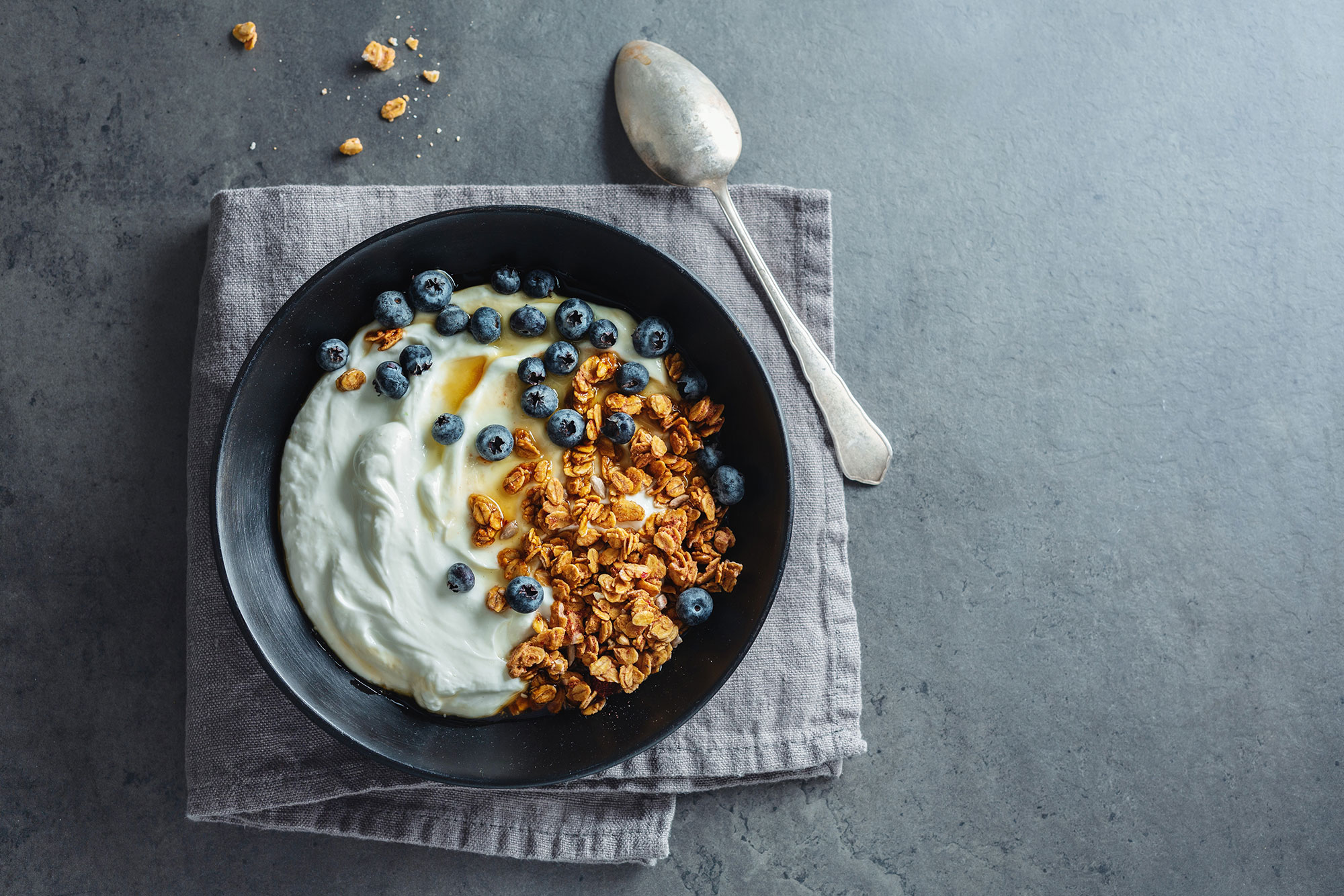 Homemade sous-vide yogurt served with granola and blueberries