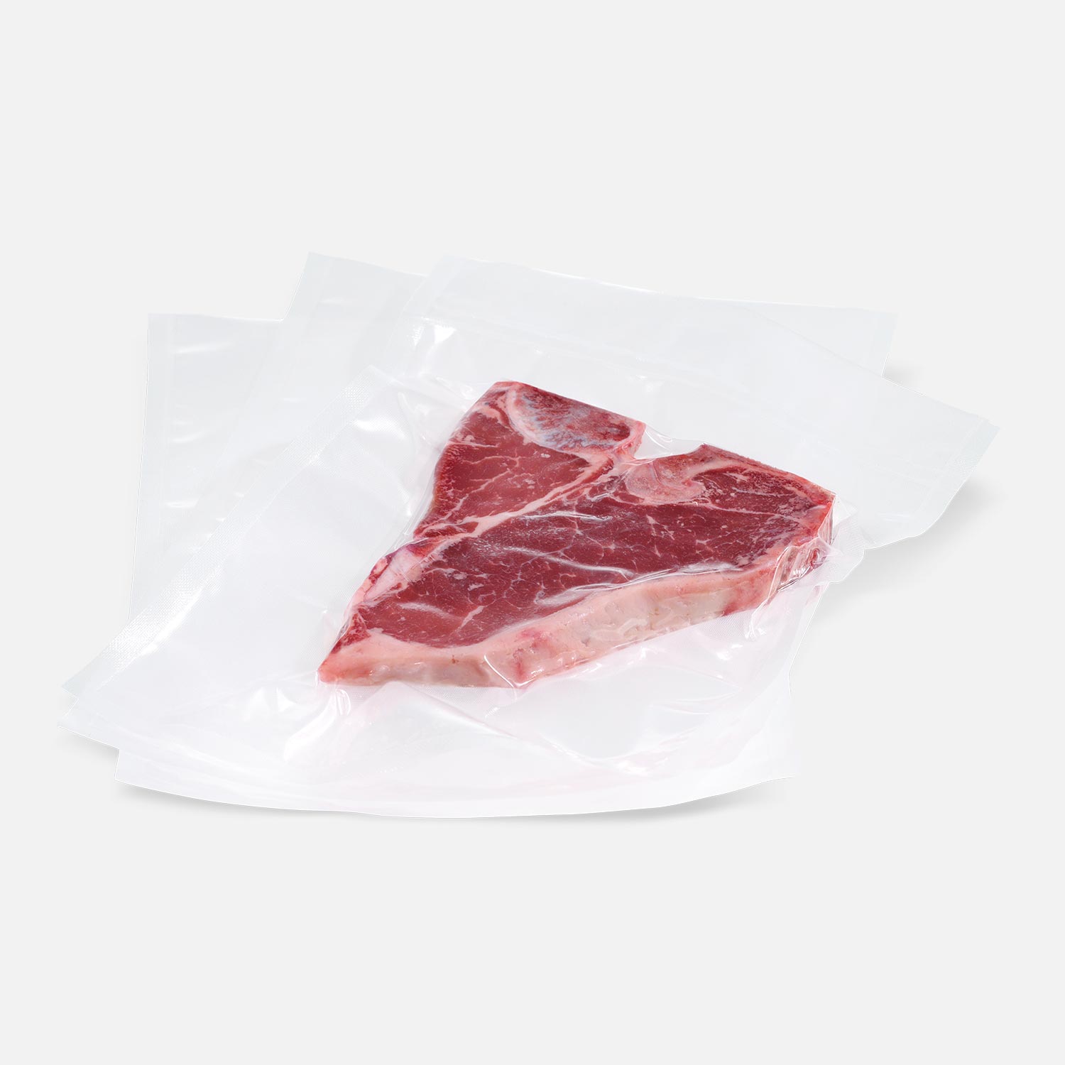 Transparent structured vacuum bag with T-Bone steak vacuum-sealed