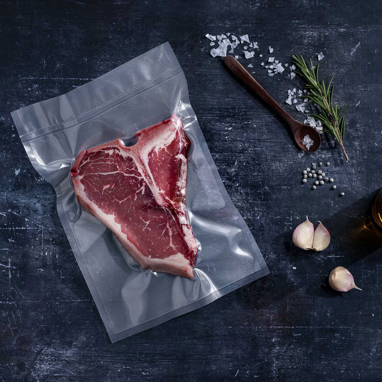Transparent strong vacuum bag vacuum-sealed with T-Bone steak