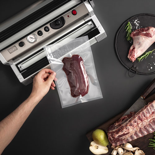 Vacuum sealing device with vacuum-sealed game meat in a vacuum bag